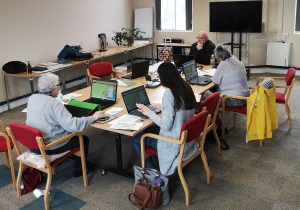 a table of people with laptops recording details on the Atlantic Geomatics maps